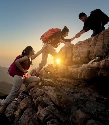 asian-hikers-helping-each-other